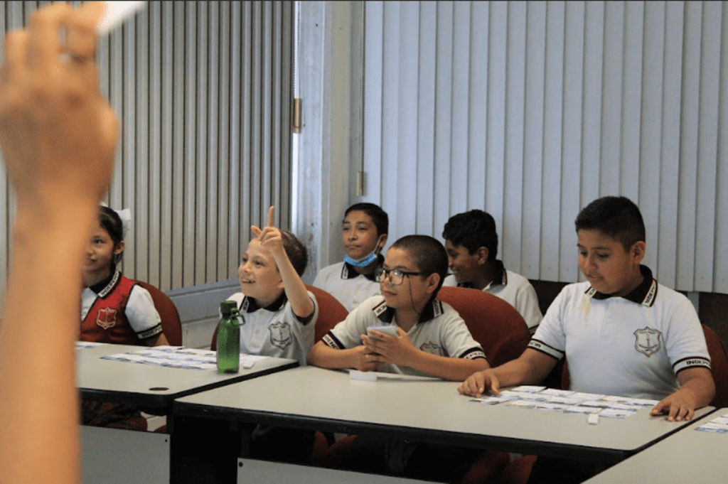 Tres niños participando en la dinamica 